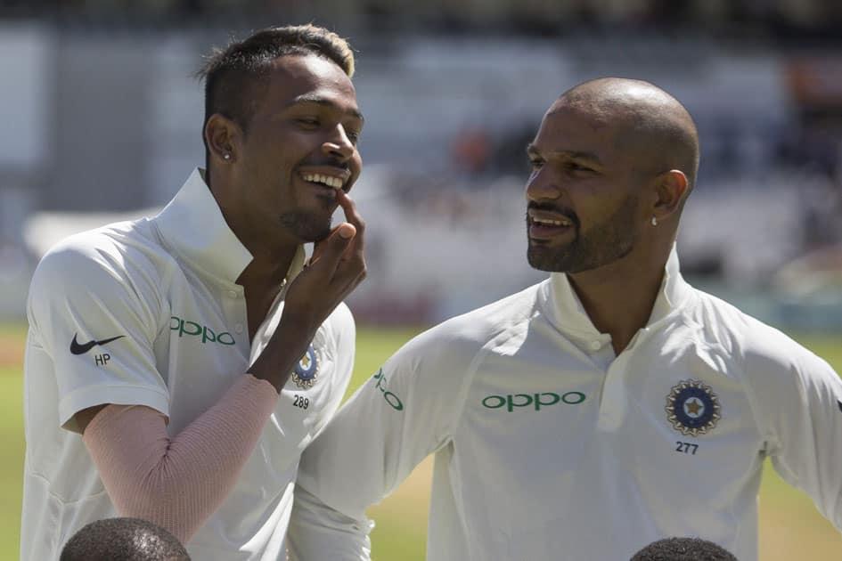 India bowler Hardik Pandya checks his teeth ahead of singing the national anthem before the first day of the first test between South Africa and India at Newlands Stadium, in Cape Town, South Africa.