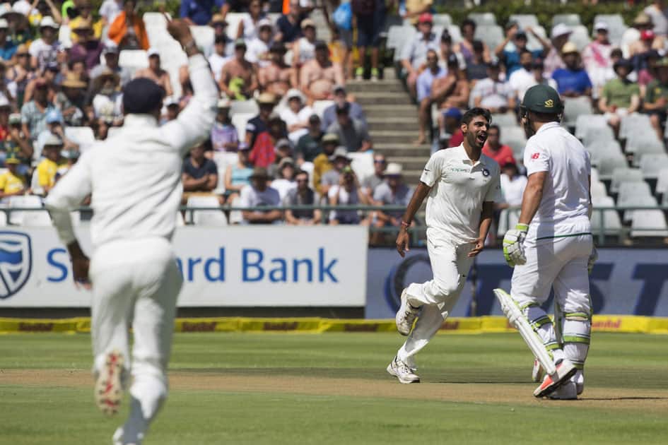 Indian fast bowler Bhuvneshwar Kumar takes the wicket of Dean Elgar of South Africa in the first over on the first day of their first day test between South Africa and India at Newlands Stadium in Cape Town, South Africa.