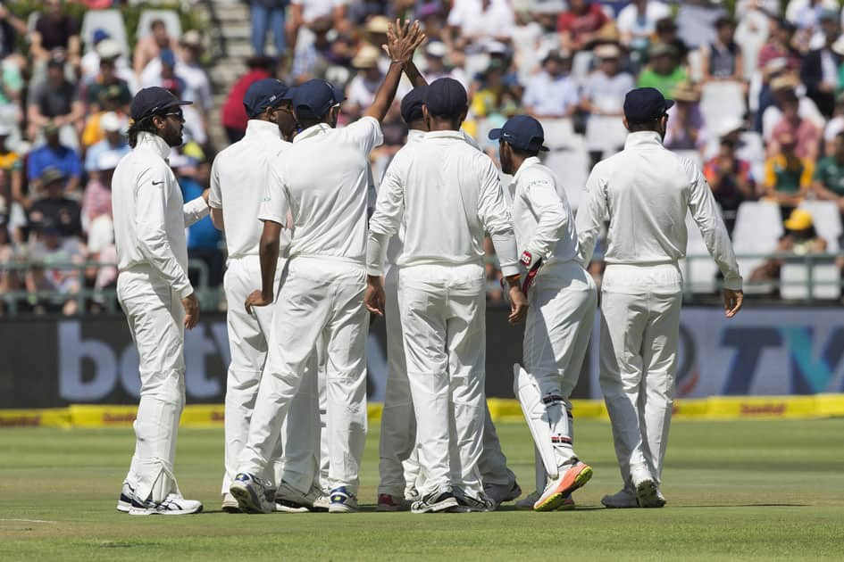 The Indian team celebrates the taking of the first South African wicket during the first over on the first day of their first day test between South Africa and India at Newlands Stadium in Cape Town, South Africa.