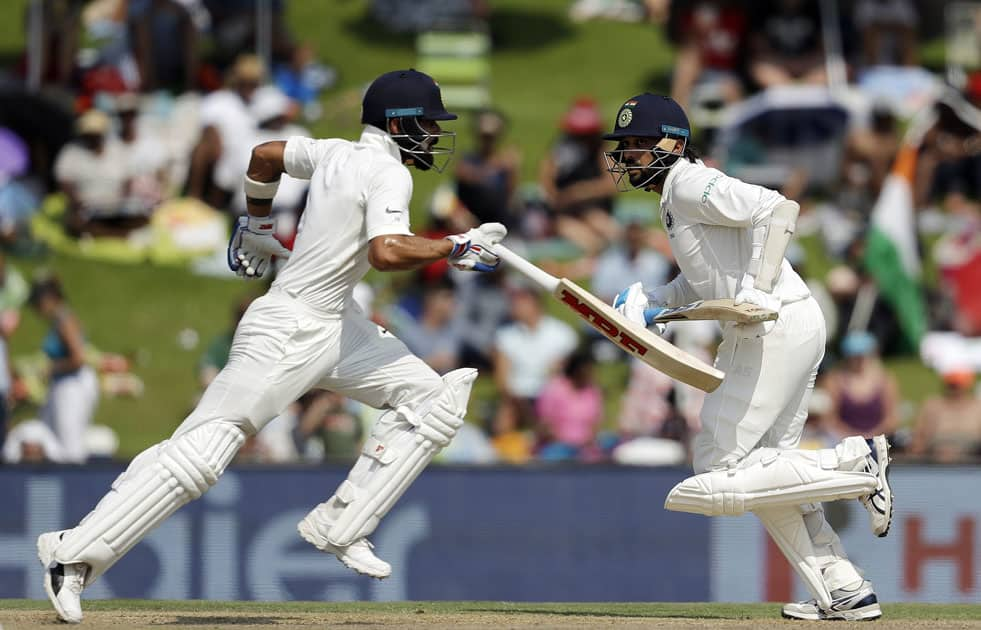 India's batsman Murali Vijay, right, with teammate Virat Kohli run between the wickets during the second day of the second cricket test match between South Africa and India at Centurion Park in Pretoria, South Africa.