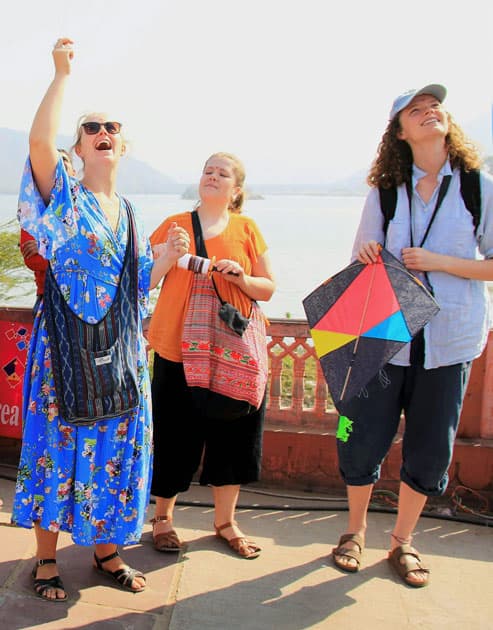 Foreign tourists flying kites on the occasion of Makar Sakranti at Jal Mahal in Jaipur.