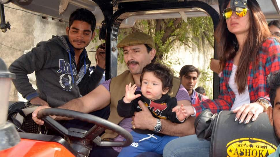 Taimur Ali Khan chilling like a boss on daddy Saif Ali Khan&#039;s lap while mommy Kareena looks at him—Pics