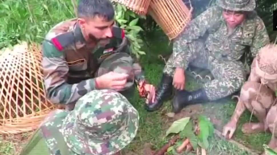 Indian soldiers learn techniques to light fire in jungle from Malaysian troopers