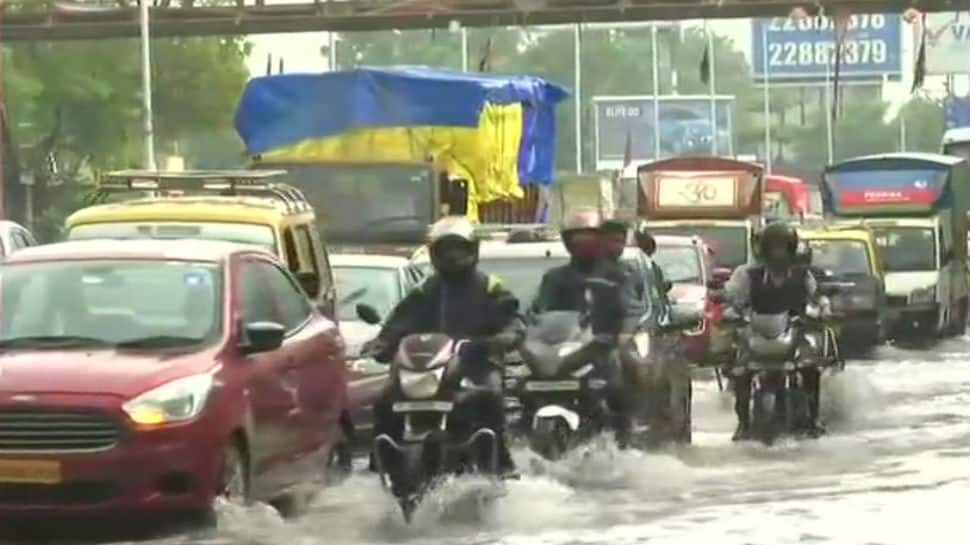 Heavy showers in Mumbai: Commuters struggle on water-logged roads, train services hit