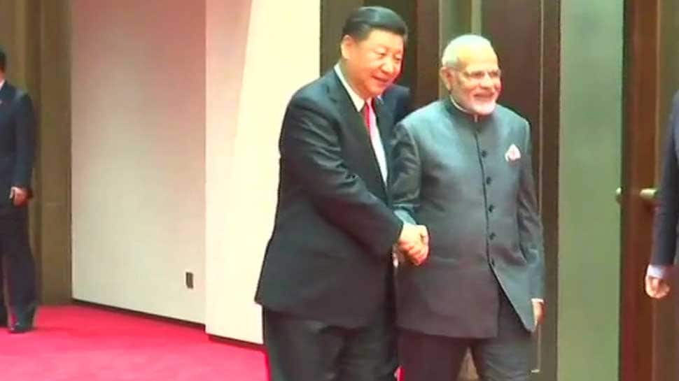 In Qingdao, China&#039;s Xi Jinping greets PM Narendra Modi with a handshake and smile ahead of SCO Summit