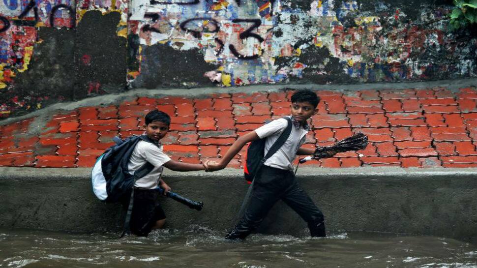 Mumbai rain live updates: Overcast sky gives way to heavy downpour