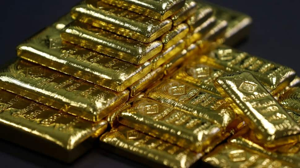 Gold slips to 1-year low as US dollar firms