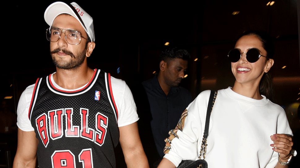 Deepika Padukone is all smiles as she walks hand-in-hand with Ranveer Singh at the airport - See pics