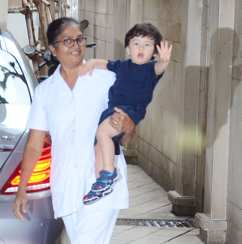 Taimur waves at the paparazzi.