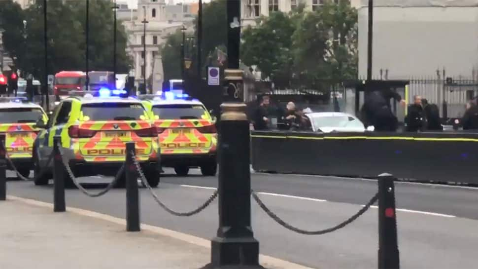 Car crashes into UK parliament barriers, several pedestrians injured