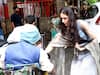 Sara Ali Khan giving alms to a needy man outside a temple.