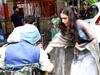 Sara Ali Khan giving alms to a needy man outside a temple.