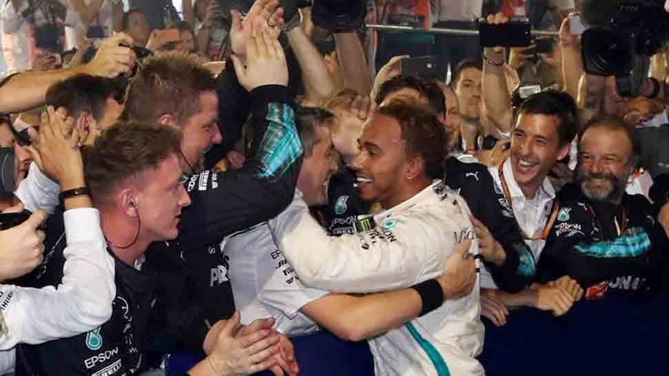 Motor racing: &#039;Spent&#039; Hamilton soaks up special victory in Singapore