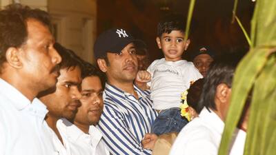 Tusshar carrying son Laksshya in arms.