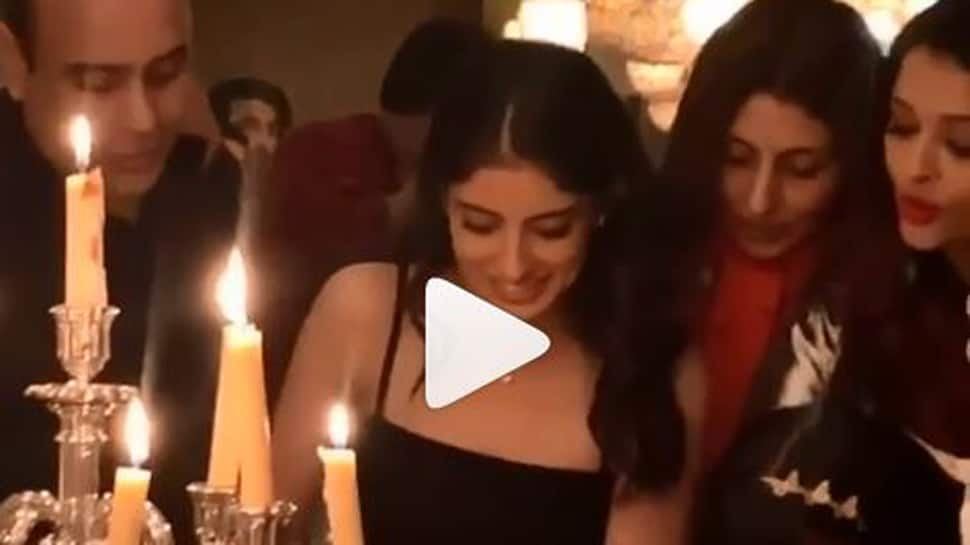 Aaradhya Bachchan looks on while sister Navya Naveli Nanda cuts her birthday cake-Watch