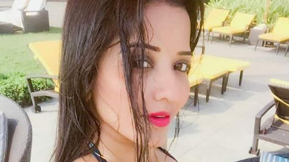 Monalisa sets the temperature soaring in a multi-coloured swimsuit-See pic