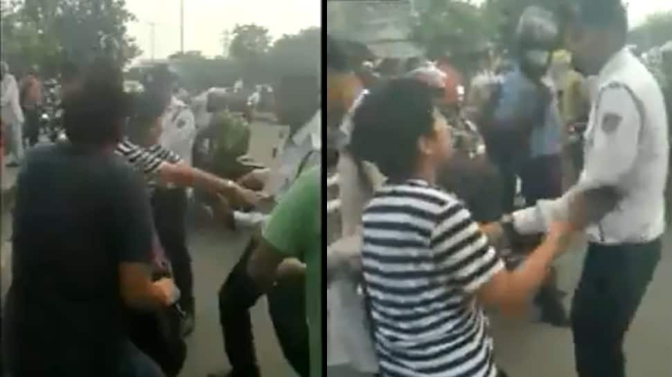 Watch: Stopped for not wearing helmet in Delhi, woman abuses, clashes with traffic cop