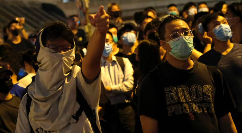 New protest erupts as Hong Kong charges 44 activists with rioting