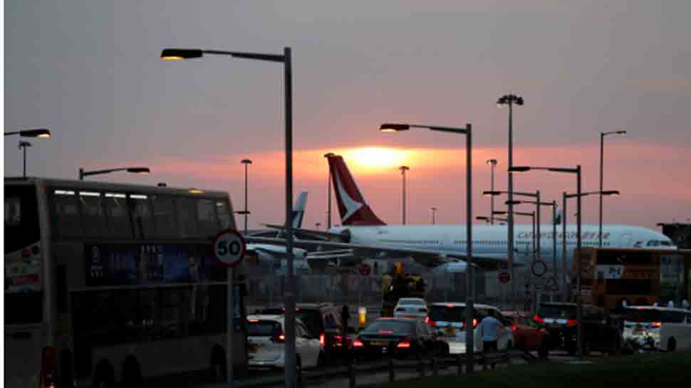 Hong Kong airport grinds to halt as China likens protests to terrorism