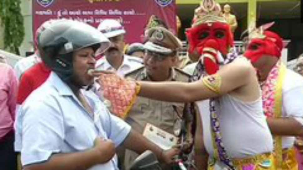 In pics: Lord Ganpati offers laddoos to those riding bike wearing helmet in Rajkot