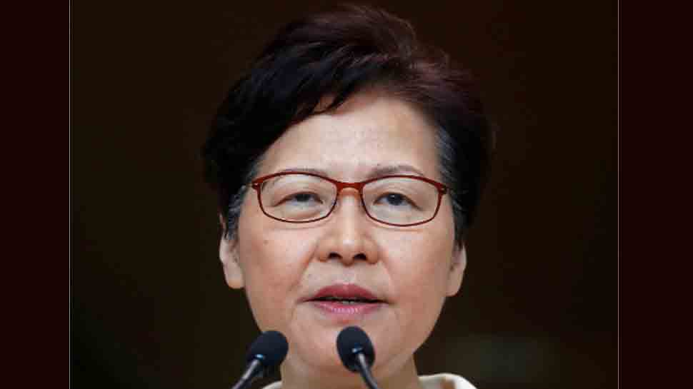 Hong Kong leader offers no olive branch as jeers force her to abandon address