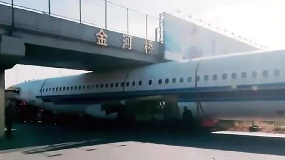 Plane gets stuck under footbridge in China - watch viral video 