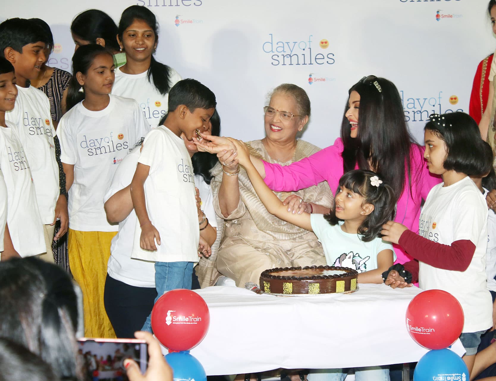 The happy kids as Ash treats them with a cake