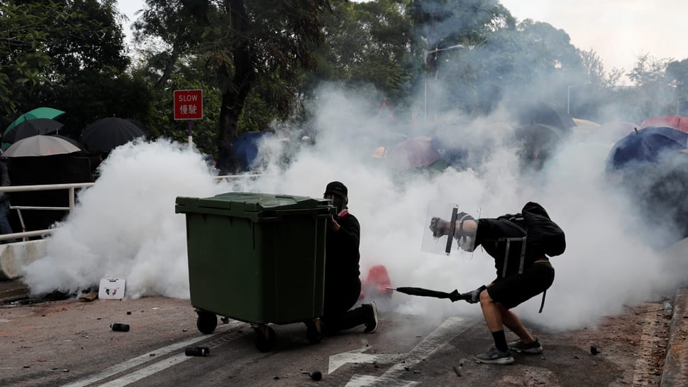 Handful of Hong Kong protesters surrender as university siege staggers on