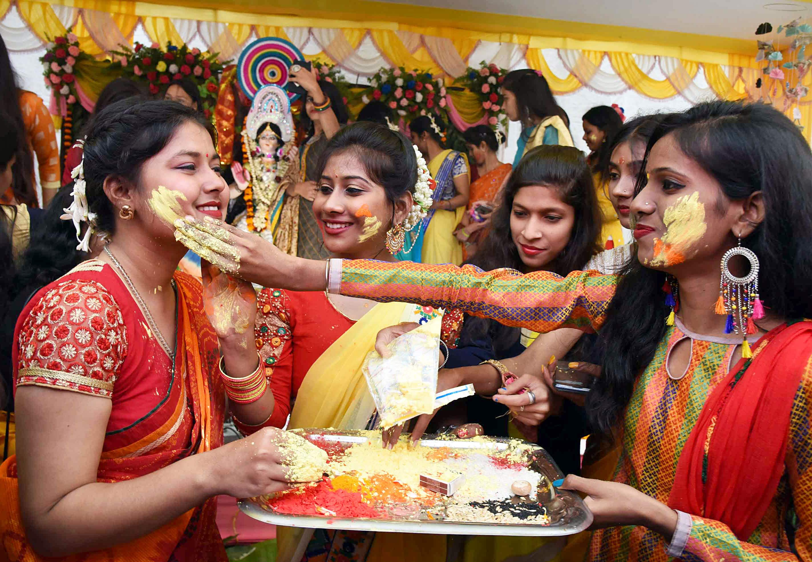 Students play with gulal on Saraswati Puja