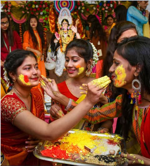 Students apply gulal on Saraswati Puja