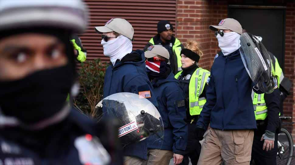 Masked white nationalists march in Washington with police escort