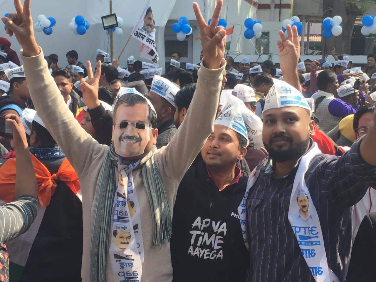 Supporters celebrating with Kejriwal's mask on