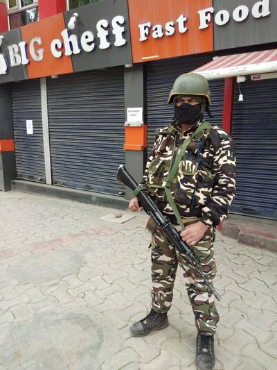 A CRPF Jawan keeps vigil and stands guard at busiest Srinagar market