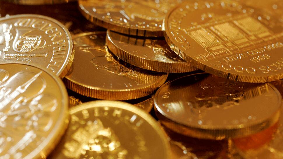 Gold eases from one-month high as dollar firms on coronavirus slowdown hopes