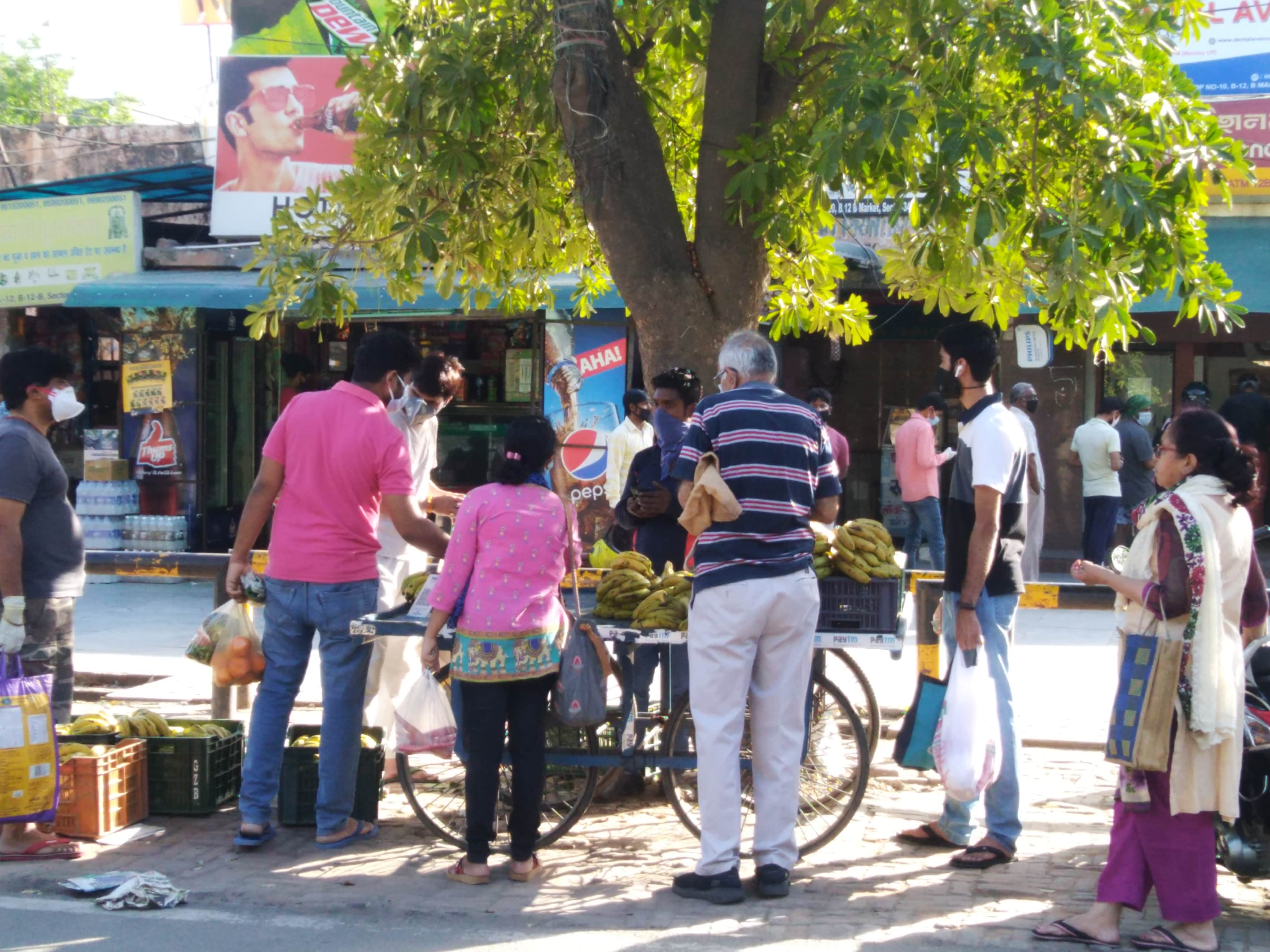 People buying fruits in Noida sector 34