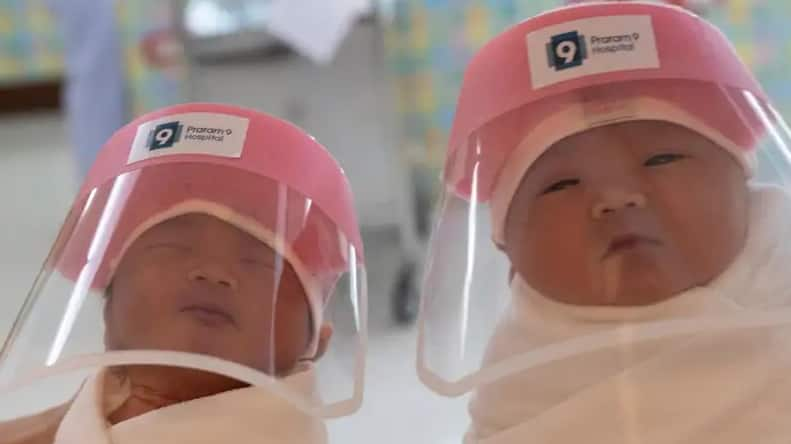 Newborns wear face shields for protection against coronavirus COVID-19 in Thailand hospitals