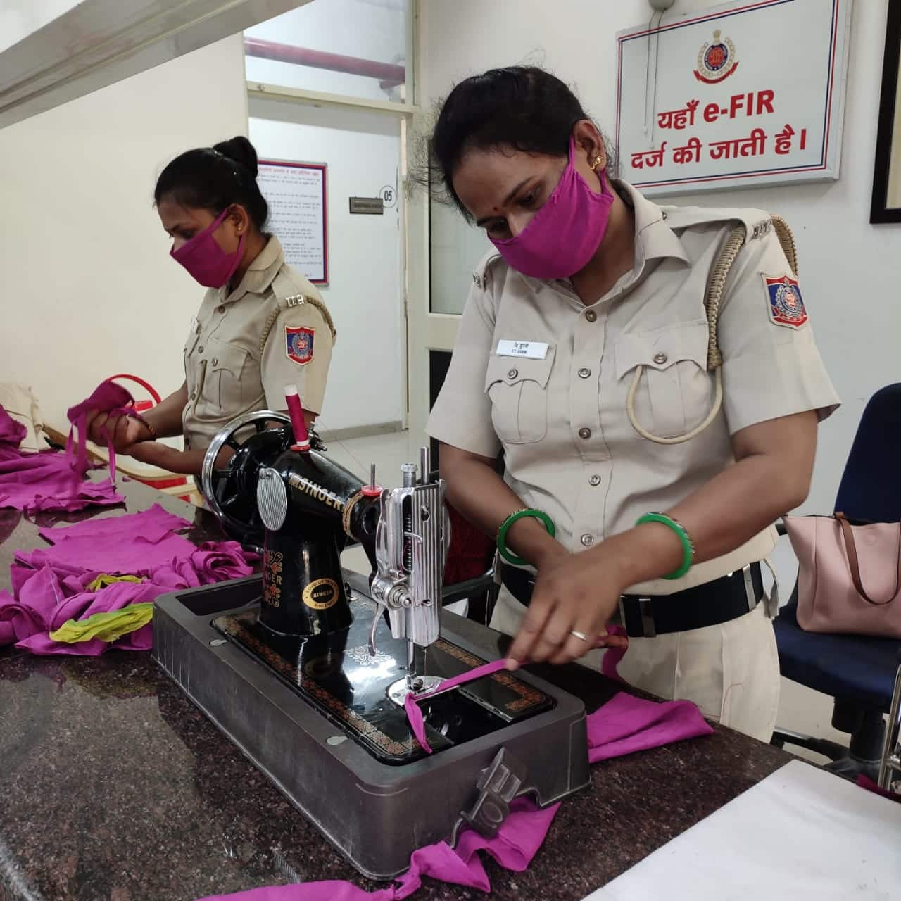 Delhi police women personnel making face masks