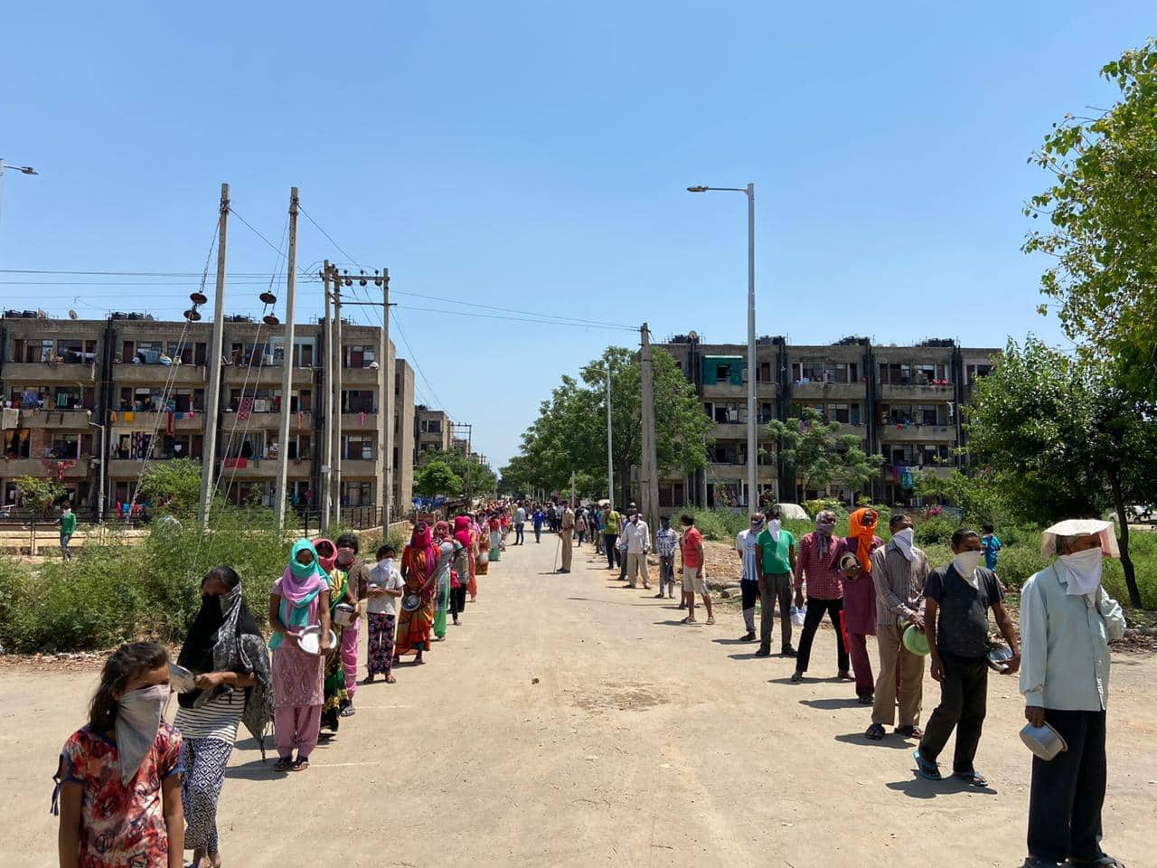 People wait in queue to get food