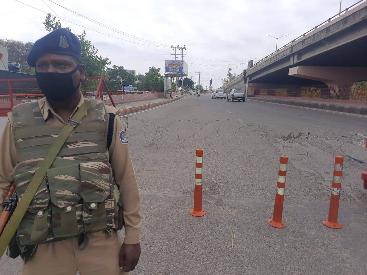 Security personnel check movement of people at Dogra Chowk, Jammu