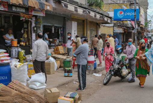 People following social distancing norms as they wait to buy essential items from shops in Jammu