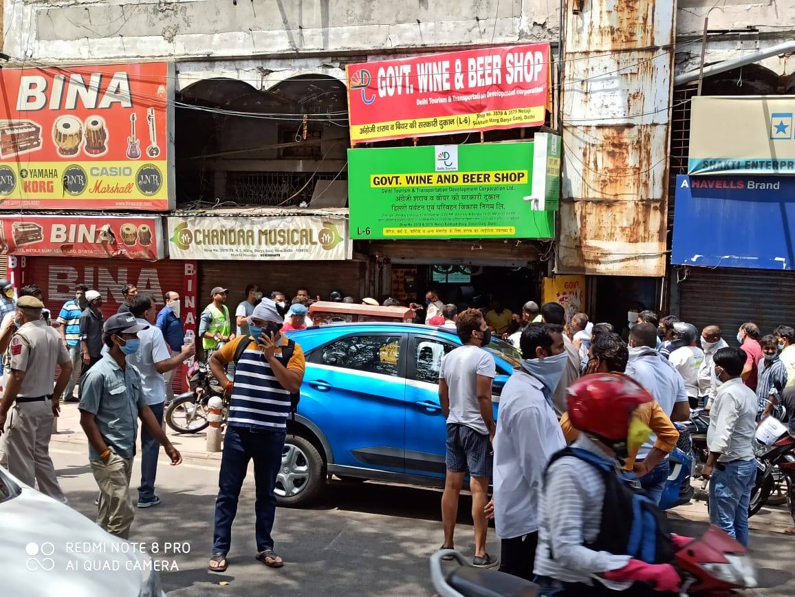 People violate social distancing norms outside liquor shop