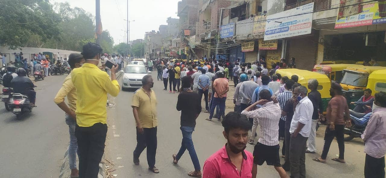 People stand in long queue in Delhi Khichripur area to purchase liquor