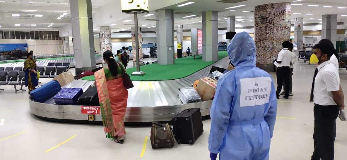 Passengers collecting luggage  at Chennai airport