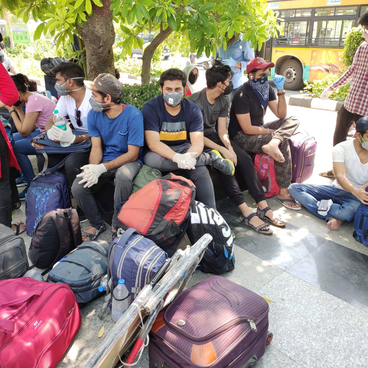 Students waiting with their luggage for screening outside Delhi's Ambedkar Stadium  