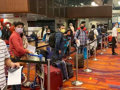 People waiting to board the Singapore- Kochi flight