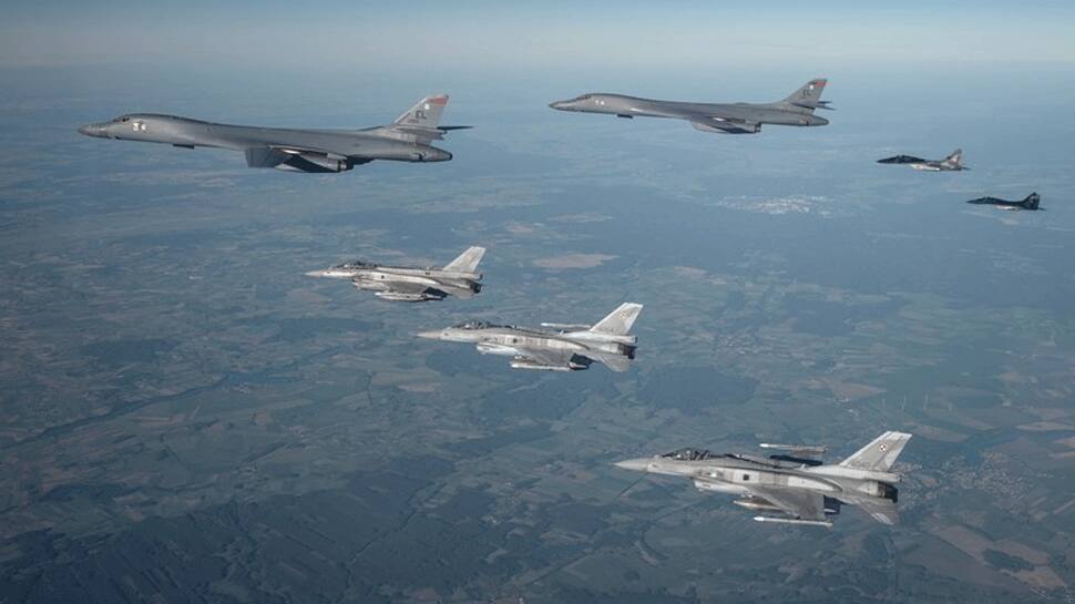 US Air Force B-1B Lancer gets escorted by F-16s , MiG-29s, Su-27s ...