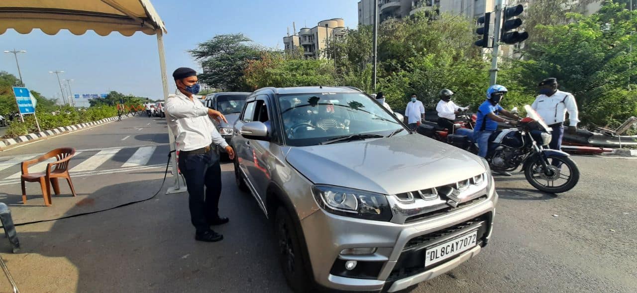 Police check vehicle pass in Delhi-Noida border