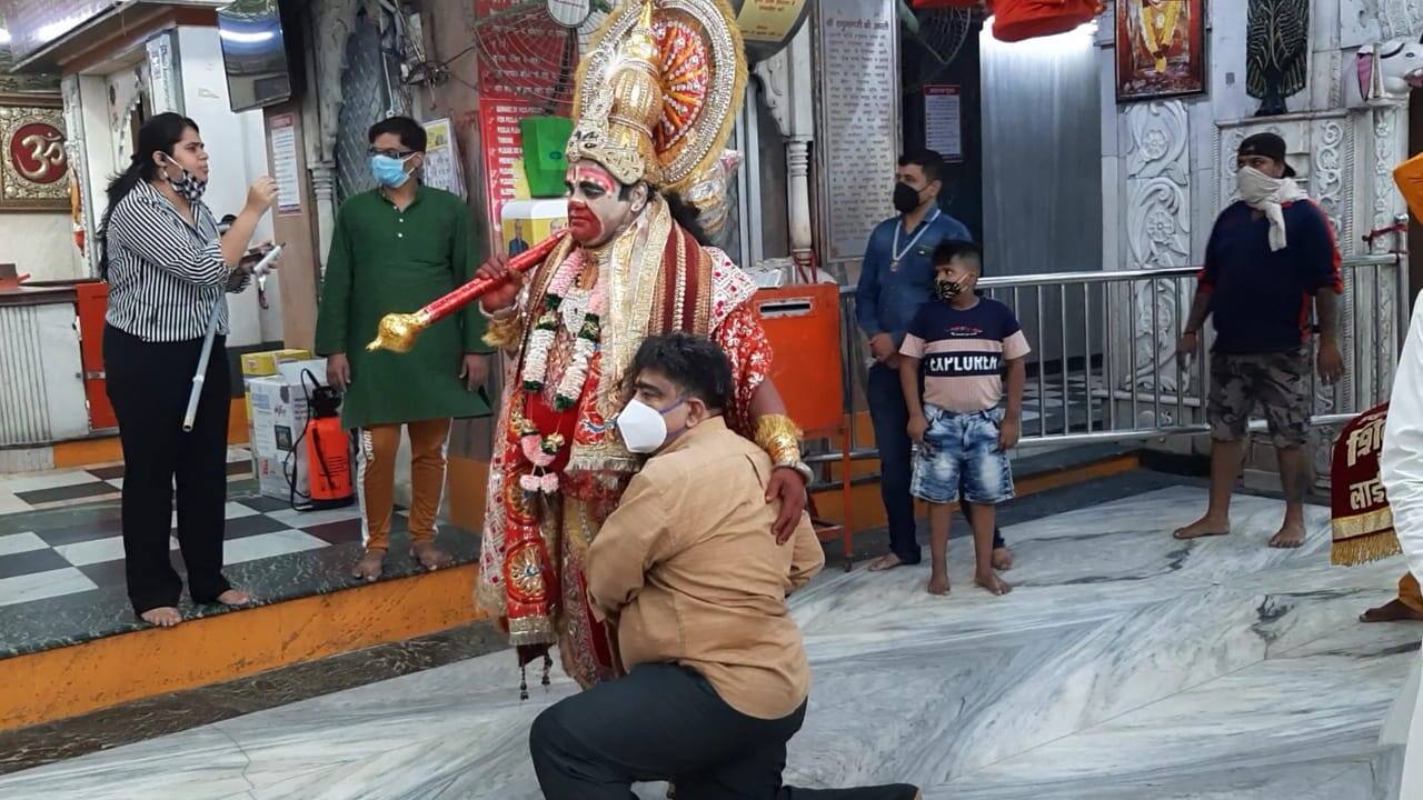 Devotees click selfiee with man dressed as Hanuman in Delhi's Connaught Place Hanuman Temple