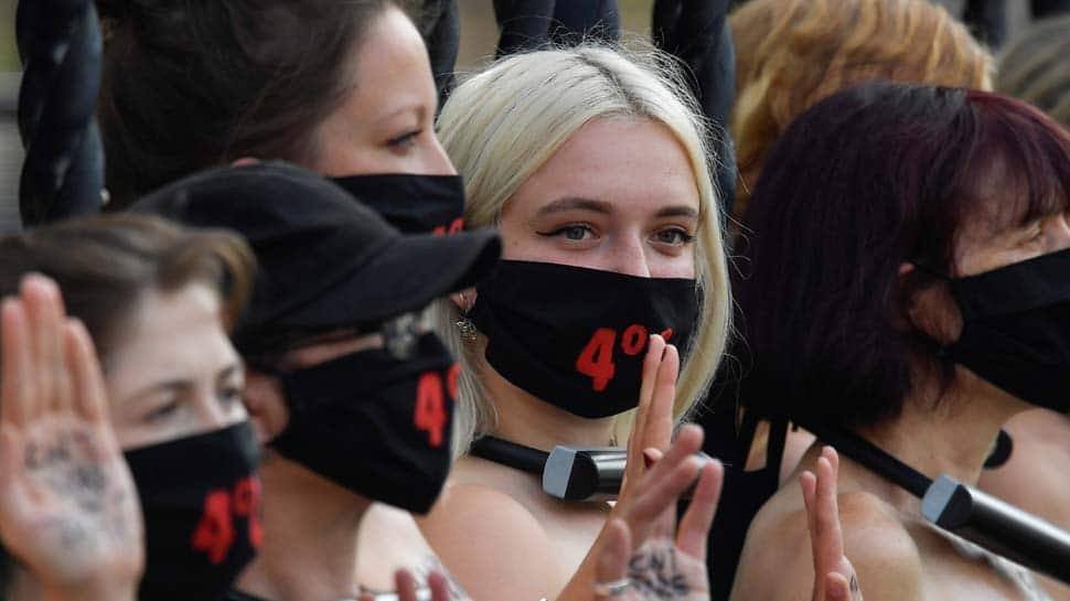 Bare-chested women lock themselves to UK parliament in climate protest