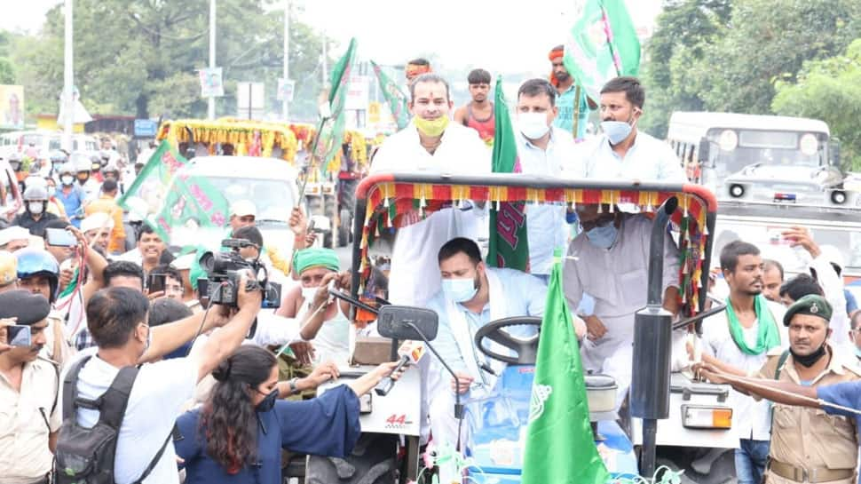 RJD leader Tejashwi Yadav drives tractor, brother Tej Pratap Yadav sits atop it during protest over Farm Bills: Watch